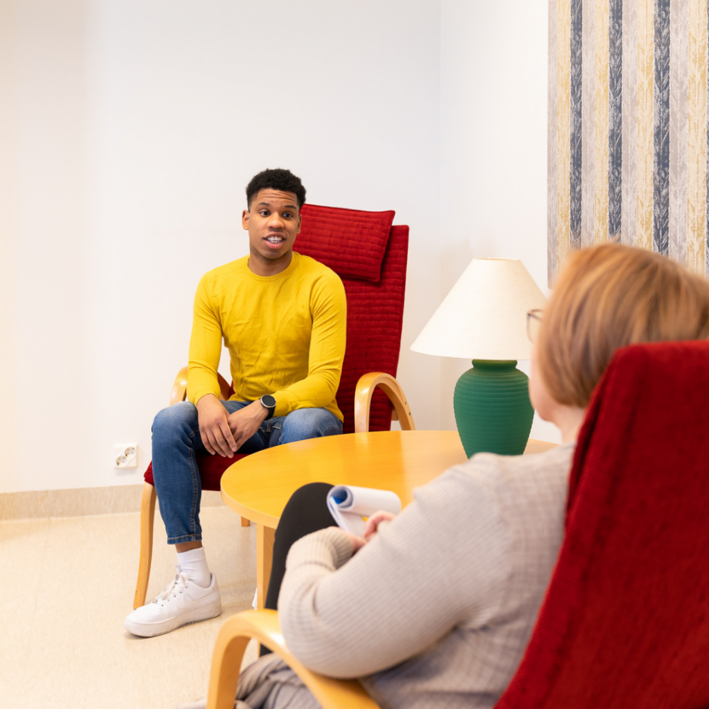 Male student at the reception of a mental health professional.